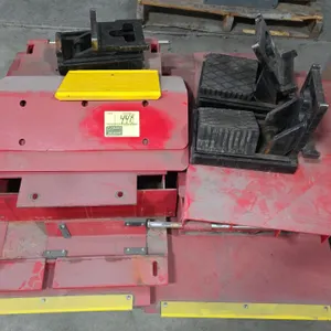 Rotary drive-on automotive lift platform parts and accessories. Includes wheel chocks, ramps, and steel platform components. Finished in red and yello