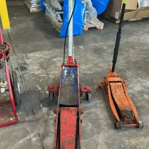 10-ton commercial hydraulic floor jack. Features long-chassis steel frame, T-handle with release control, pneumatic air valve assembly, front steel ro
