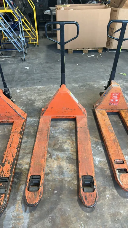 Noblelift manual pallet jack. Features manual hydraulic operation, steel construction, loop control handle with fingertip release lever, dual steer wh