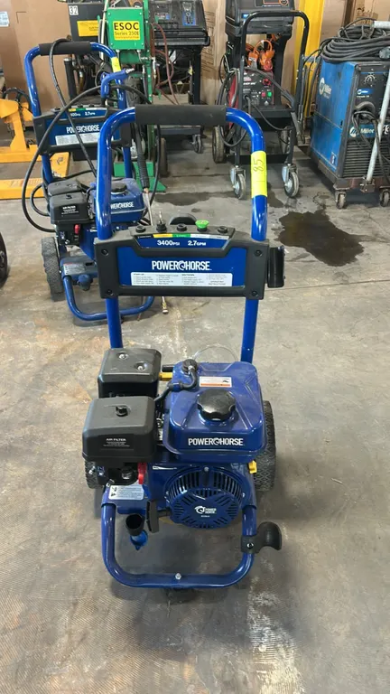 Powerhorse gas cold water pressure washer. Features an upper console with quick-connect nozzle holders. Powered by a Powerhorse 212cc gas engine. Deli