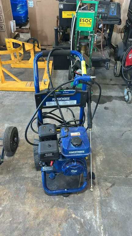Powerhorse gas cold water pressure washer. Features an integrated spray nozzle holder. Includes spray wand and high-pressure hose. Powered by a 212cc