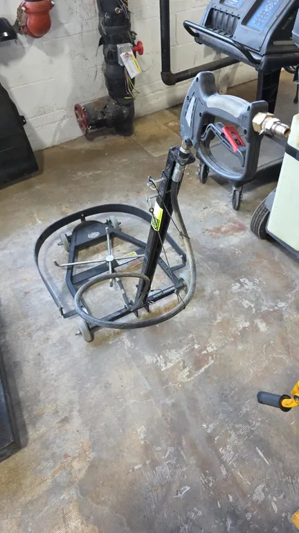 Steel Eagle Bottom Feeder undercarriage cleaner pressure washer attachment. Features a 4-nozzle rotary spray assembly, integrated trigger spray gun wi