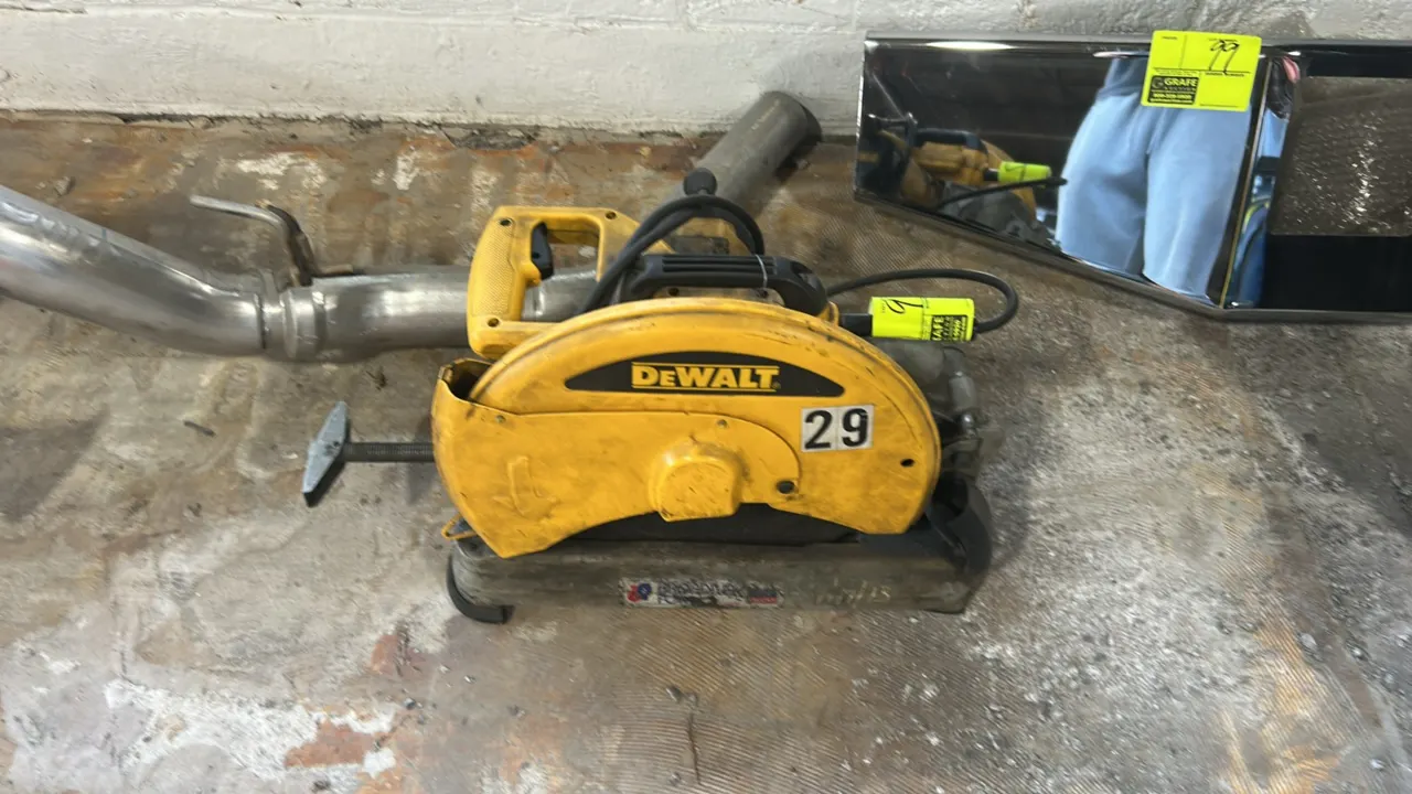 DeWalt D28715 14" corded chop saw. Features an ergonomic D-handle, integrated top carrying handle, protective wheel guard, and quick-lock vise clamp.