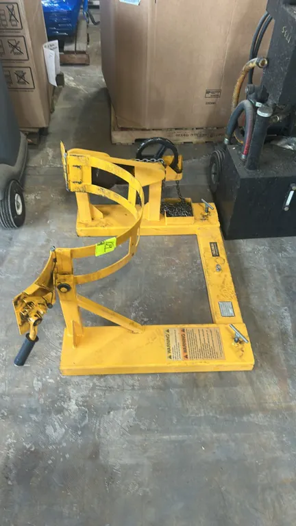 Global Industrial HK285B fork truck drum carrier. Designed for 55-gallon steel drums. Features a 1,500 lb capacity, manual chain-operated drum rotatio