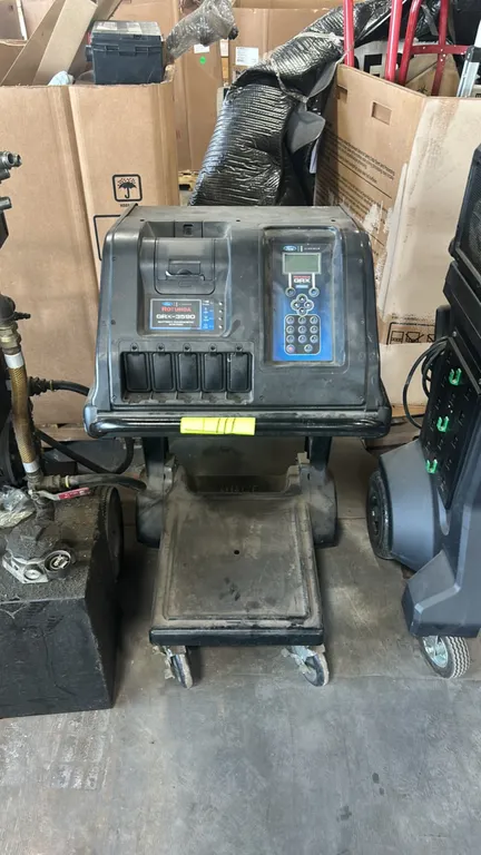 Midtronics Rotunda GRX-3590 battery diagnostic station. Features digital LCD display, numeric keypad controls, integrated printer, and cable storage.