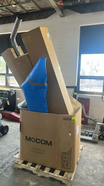 Pallet lot of automotive parts and accessories. Includes stainless-steel cat-back exhaust system with muffler, poly fender wrapped in blue protective