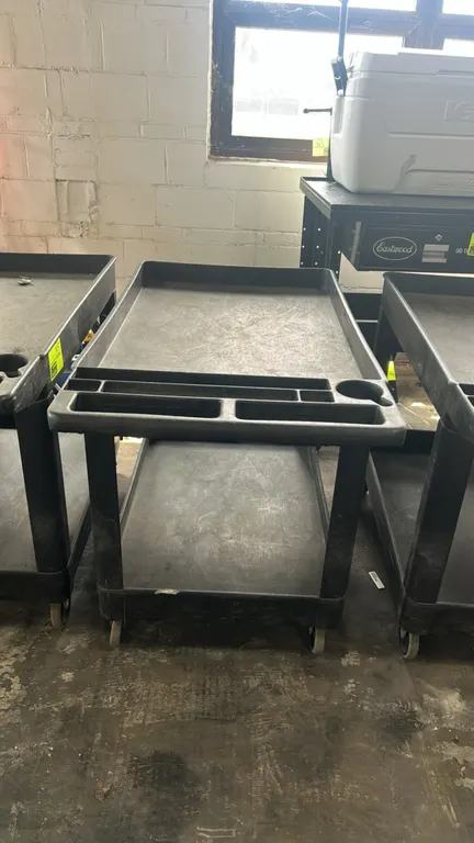 Poly 2-tier utility service cart. Features molded-in push handle with integrated tool compartments and cup holder and (2) tub-style shelves. 44"L. Mou