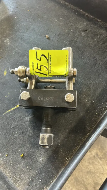 Pitman arm puller. Marked 533180. Features dual clamping jaws with cross-bolts, steel cross block, and threaded center forcing screw with hex drive.