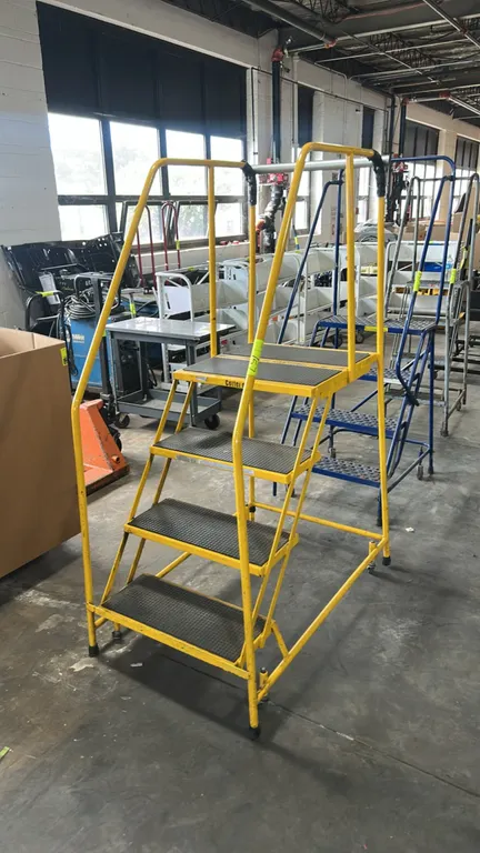 Cotterman rolling steel safety ladder. Features 4 steps including top platform, slip-resistant tread, tubular steel handrails, and spring-loaded caste