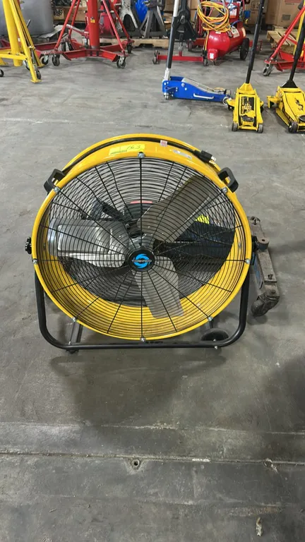 Tornado HI-FAN-DRUM24-1P 24" portable tilt blower drum fan. Features 3-blade design, metal drum housing, dual carry handles, and adjustable tilt cradl