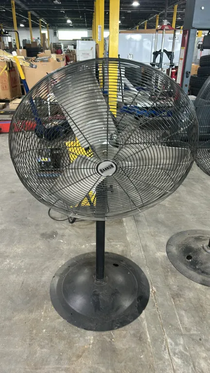 Bannon 3' oscillating pedestal shop fan. Features a 3-blade metal propeller, wire safety cage, and rotating head. Mounted on a pedestal stand with a w