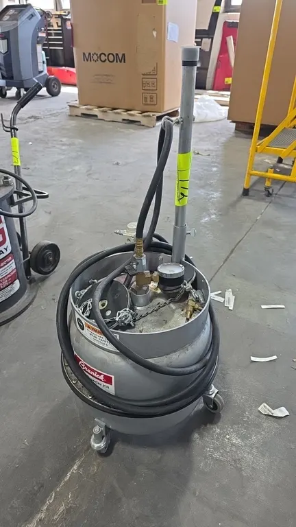 Branick G-300 pressure brake bleeder. Features steel pressure tank, pressure gauge, air regulator assembly, fluid dispensing hose, and master cylinder