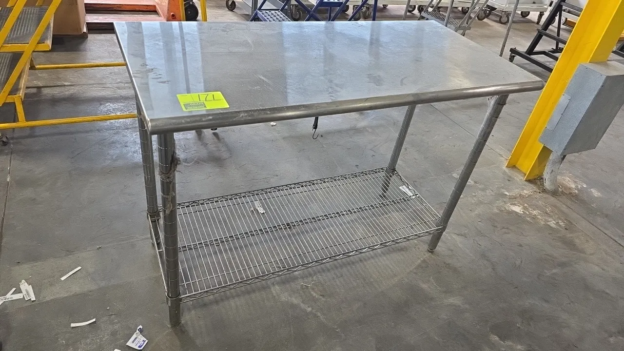 Stainless steel top work table. Features a stainless steel flat top and wire undershelf. 50"L x 24"W. Mounted on tubular metal legs with leveling feet