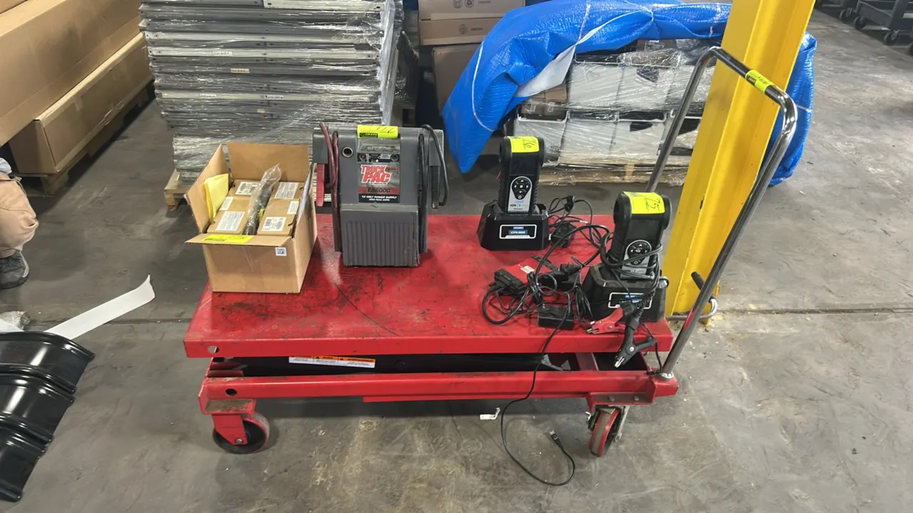 Dayton 4ZD01J hydraulic scissor lift table cart. Features foot pedal hydraulic lift mechanism, release lever, and tubular push handle. 1,500 lb capaci