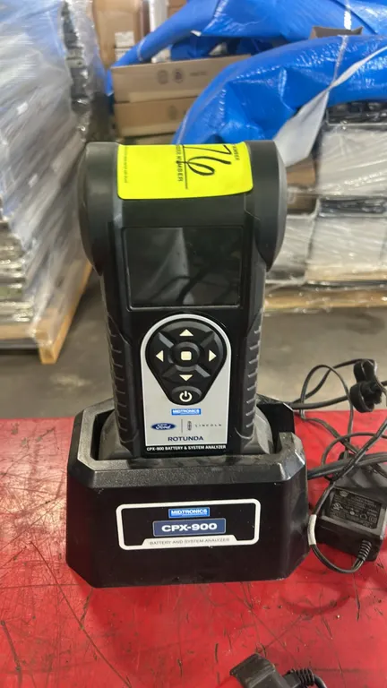 Midtronics CPX-900 Rotunda battery and electrical system analyzer. Features digital display, navigational keypad, integrated testing clamps, and deskt