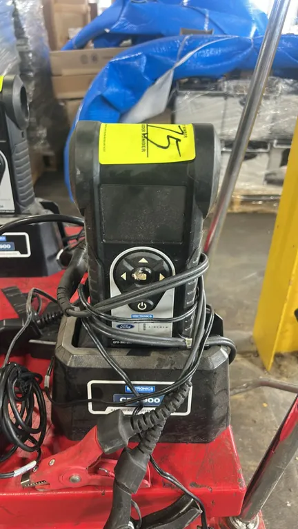 Midtronics CPX-900 battery and electrical system analyzer. Features Ford and Lincoln branding, digital display screen, and directional keypad controls