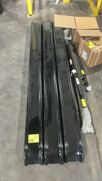 Metal automotive running boards. Features black finish with textured step surface and pre-drilled mounting holes. 8'L. Background items not included.