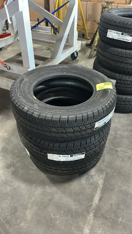 Hankook Dynapro HT RH12 highway all-season tires. Size: 205/75R16. Ply rating: 10PR. Background items not included.
