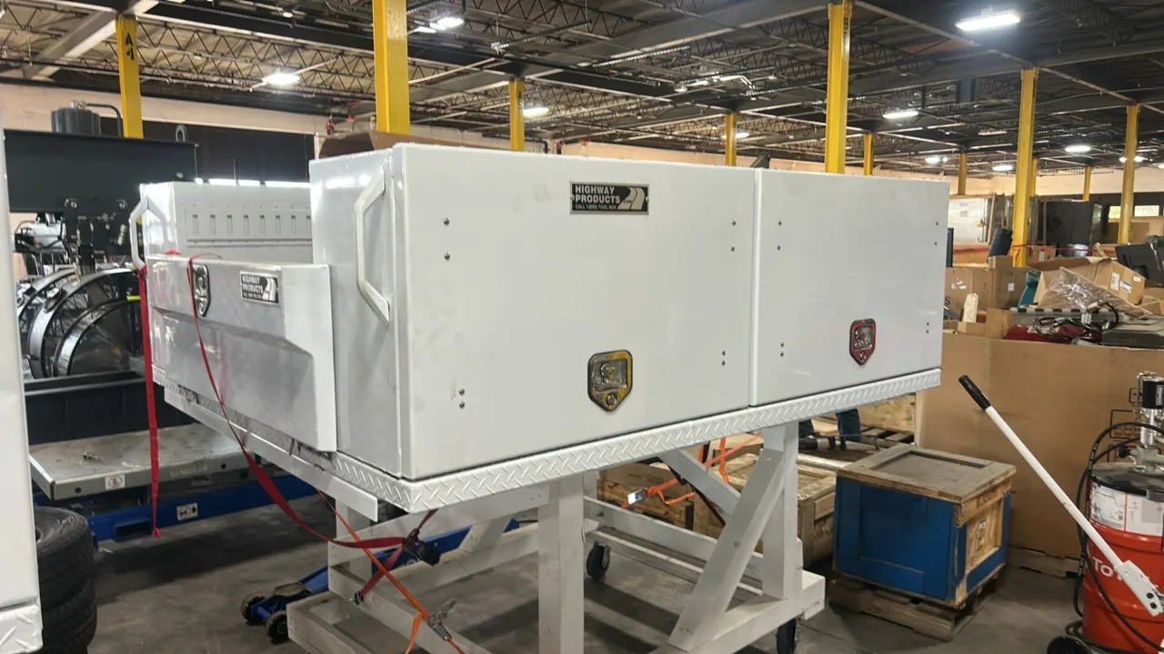 Highway Products topsider truck tool box. Features dual side compartments with drop-down doors, locking T-handle latches, grab handles, and diamond pl