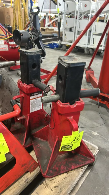 Sunex 22-ton pin-type jack stands. Features steel construction, tethered locking support pins with safety cables, integrated carrying handles, and wid
