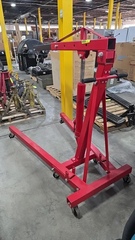 Strongway 46219 2-ton folding hydraulic engine hoist. Features a 4-position adjustable boom (1/2-ton, 1-ton, 1-1/2-ton, and 2-ton), manual hydraulic c