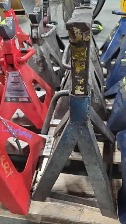 Adjustable 6-ton jack stands. Features ratchet-style height adjustment with locking pawl handles, cast support columns with contoured saddles, and wel