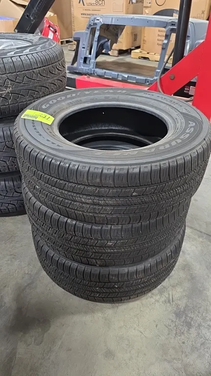 Used Goodyear Assurance all-season tires. Size: 235/65R16 with 103T load and speed rating. Features M+S (Mud and Snow) rating.