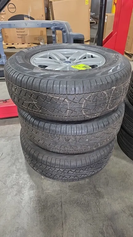Used Pirelli Scorpion ATR tires mounted on Ford 6-lug alloy wheels. Tire size: 265/70R17 115T M+S. Features 6-spoke painted finish with Ford center ca