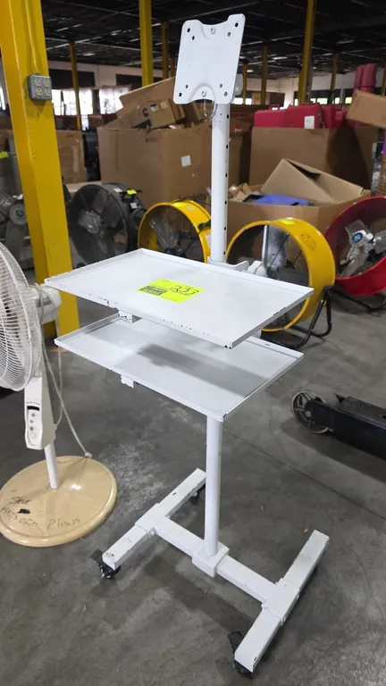 Portable monitor stand. Features VESA display mount bracket, two adjustable metal shelves, and height-adjustable center column. Mounted on an H-frame