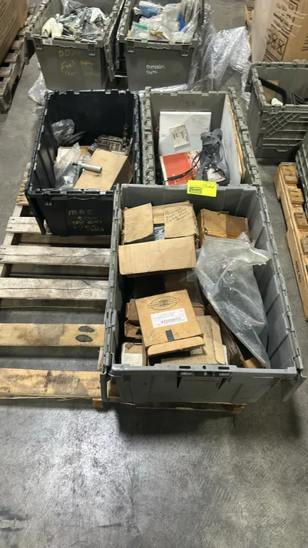 Poly totes containing assorted heavy-duty truck parts and components. Includes Allison transmission control module (P/N 29551869), Allison 3000-4000 c