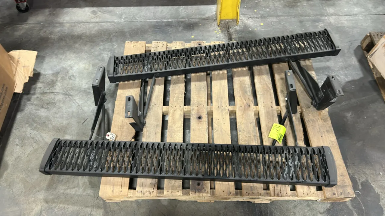 Steel running board set. Features black finish, serrated expanded metal traction step surfaces, and molded end caps. Includes attached mounting bracke