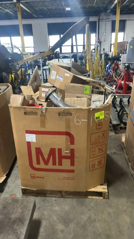 Assorted Ford and Motorcraft automotive parts in Gaylord container. Includes OEM exhaust front pipe/downpipe (P/N HC3Z-5N646-A), automatic transmissio