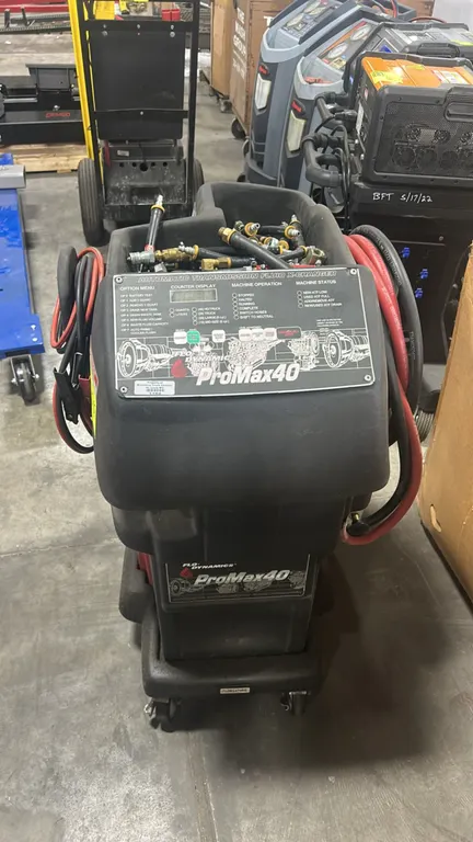 Flo-Dynamics ProMax40 automatic transmission fluid inline exchanger. Features a digital control panel, fluid reservoir, top storage tray with assorted