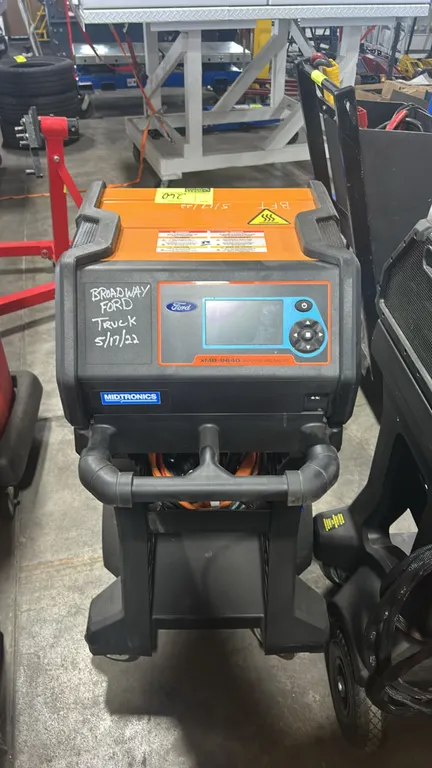 Midtronics xMB-9640 Ford battery module balancer. Features digital LCD display with directional keypad navigation, high-voltage battery cables, and re
