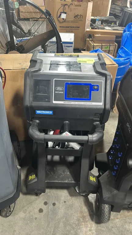 Midtronics DCA-8000 P dynamic diagnostic charging system. Features Ford Rotunda branding, digital display screen, integrated printer, and battery lead