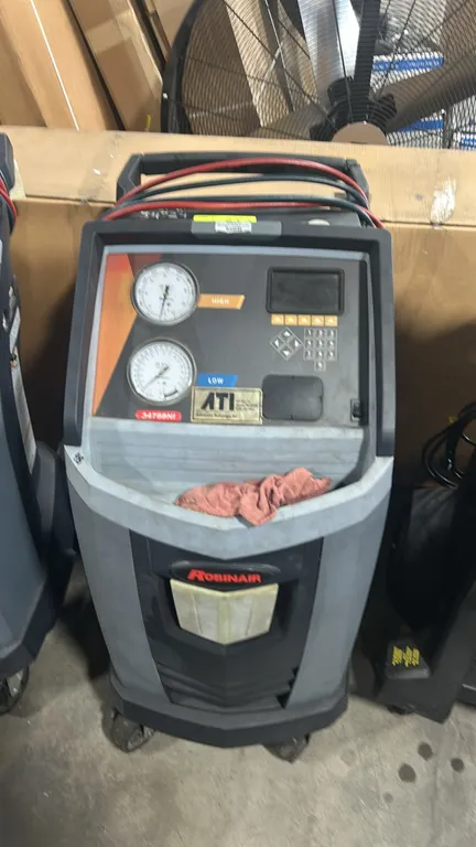 Robinair 34788NI Premier R-134a refrigerant recovery, recycling, and recharging machine. Features high and low pressure gauges, digital display with k