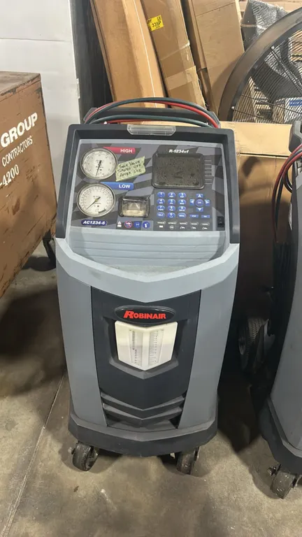 Robinair AC1234-6 R-1234yf refrigerant recovery, recycling, and recharging machine. Features digital display with keypad interface, high and low press