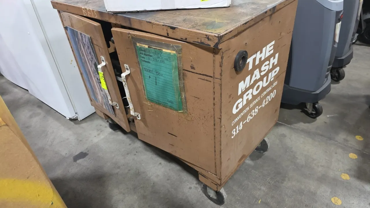 Portable 2-door steel tool cabinet and mobile work box. Features dual front doors, pull-out interior drawers, steel work surface, and includes assorte