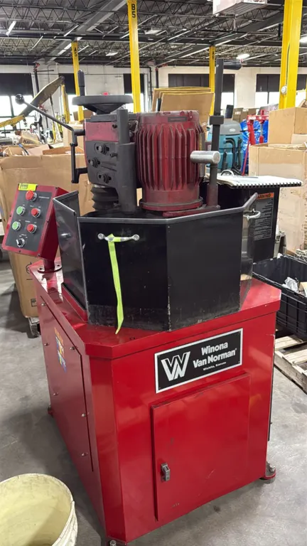 Winona Van Norman FG-5000 rotary flywheel grinder. Features 5 HP motor, rotary table with splash guard enclosure, pendant control station, integrated