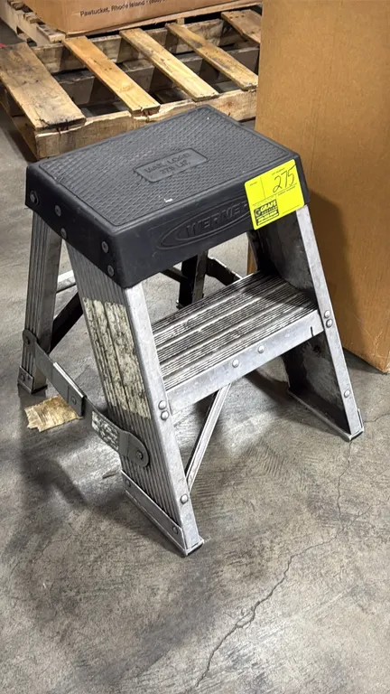 Werner 2' aluminum stepladder. Features molded black top platform with 375 lb load capacity, grooved slip-resistant aluminum step, and folding spreade