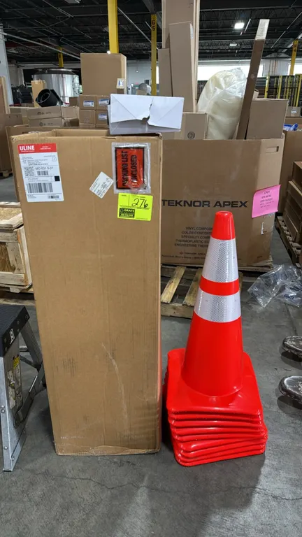 Safety supply lot. Includes orange traffic cones with dual reflective collars, boxes of Uline S-13390C Ice Wraparounds clear safety glasses (12 pairs