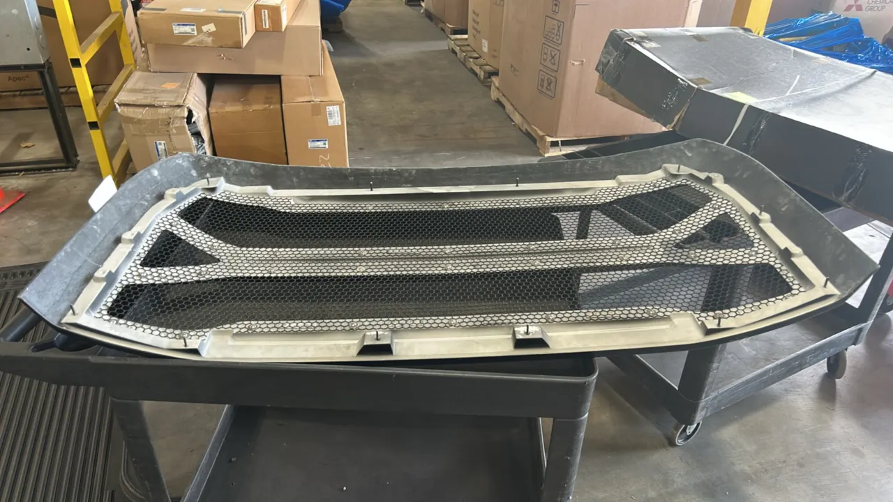 Ford truck grille. Features a gloss black finish, multi-bar design, and honeycomb mesh insert. 5'L.