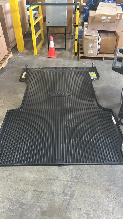 Ford Super Duty truck bed mat. Features molded black rubber construction, ribbed non-skid surface, centered Ford oval logo, and Super Duty embossed br