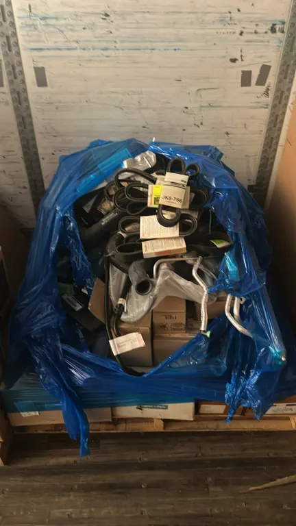 Pallet of Ford and Motorcraft OEM automotive parts. Includes Motorcraft drive belts (P/N: JK8-786), Ford right exhaust pipe mounting bracket (P/N: FC4