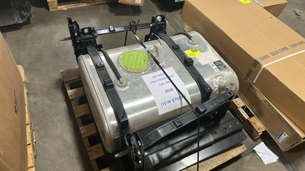 Ford F-650 / F-750 side-mount diesel fuel tank. Features aluminum construction, dual mounting straps, mounting brackets, and filler neck. Marked for d