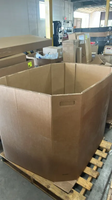 Quantity of Fleetguard LF9025 lube oil filters. Packaged in cardboard cartons within a corrugated Gaylord container on a wooden pallet. Individual box