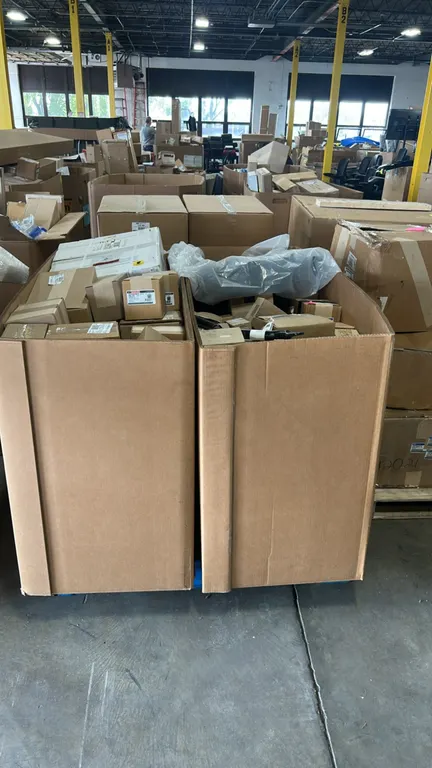 Ford and Motorcraft OEM automotive parts lot. Includes (2) Gaylord containers filled with assorted boxed components including dual-note electric vehic