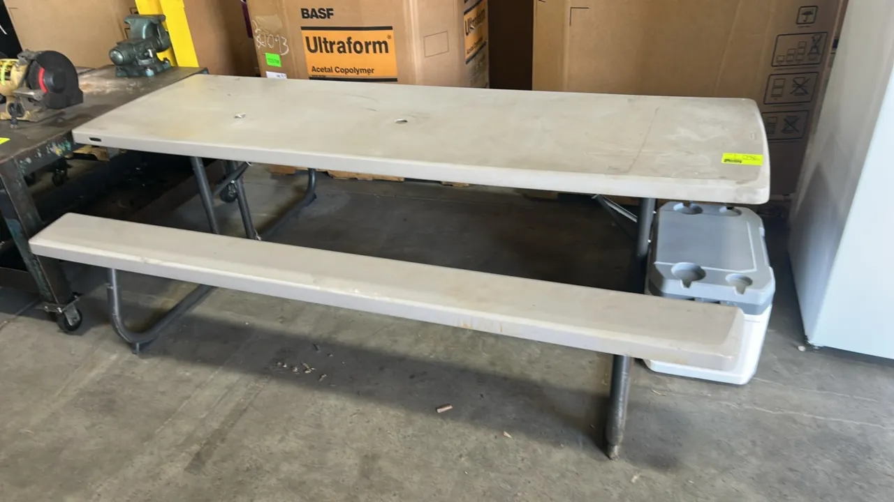 Lifetime collapsible picnic table. Features polyethylene tabletop, attached bench seats, center umbrella hole, and folding metal frame. 8' x 5'. Coole