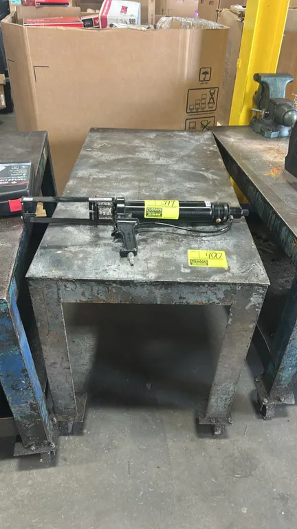 Metal 2-tier cart. Features heavy-duty steel construction. 4' x 2'. Mounted on casters. Tool on cart not included.