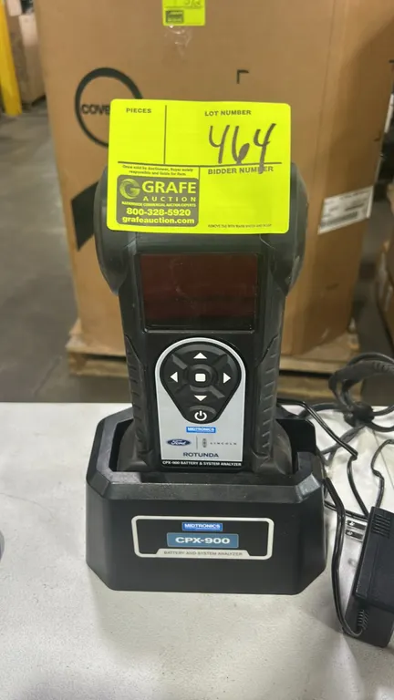 Midtronics Rotunda CPX-900 battery and electrical system analyzer. Features digital display screen, keypad navigation controls, and Ford/Lincoln brand